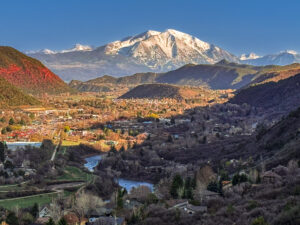 Mount Sopris illuminated by late afternoon light, viewed from Red Mountain Trail, with an angled foreground shadow