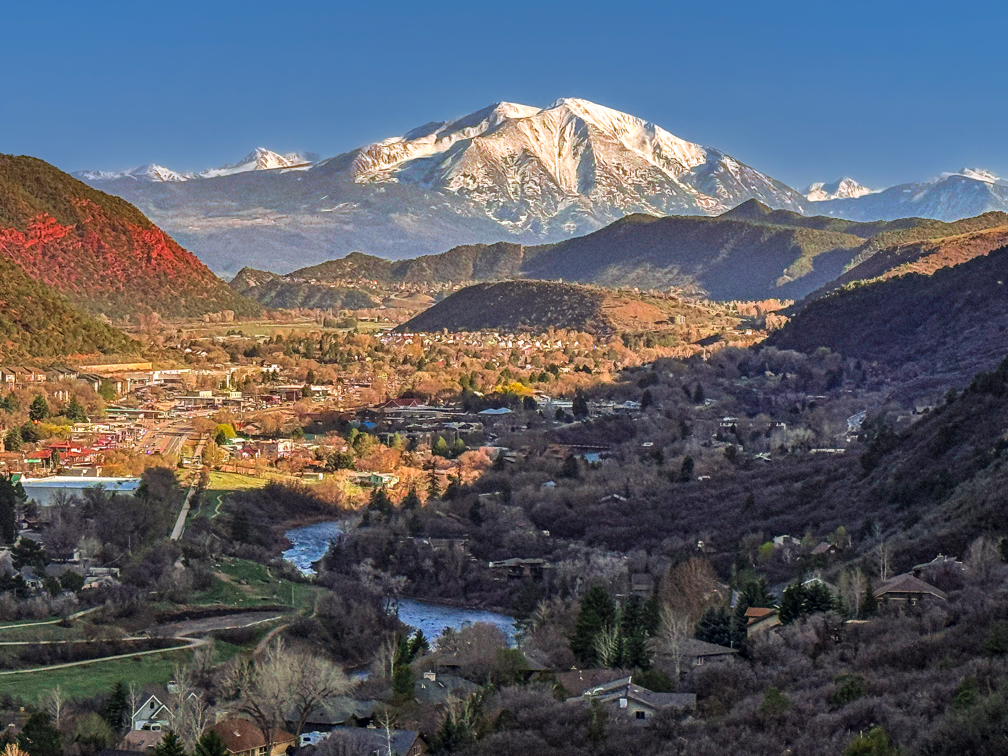 Mount Sopris illuminated by late afternoon light, viewed from Red Mountain Trail, with an angled foreground shadow
