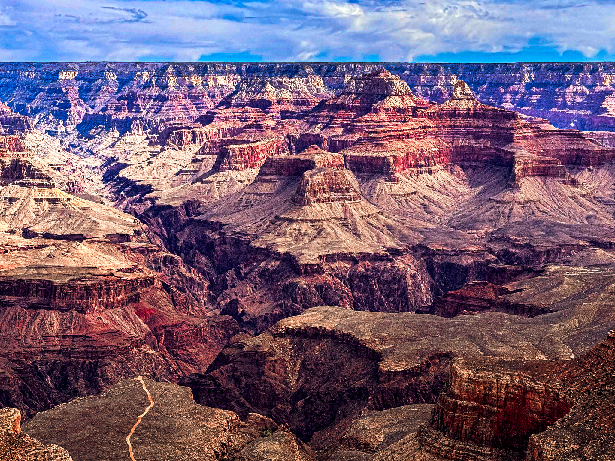 Grand Canyon sandstone peaks resembling swirls of soft ice cream, paused in a moment of golden light