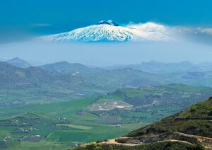 Fine art landscape photograph of snow-capped Mount Etna floating above the countryside, viewed from Enna, Sicily
